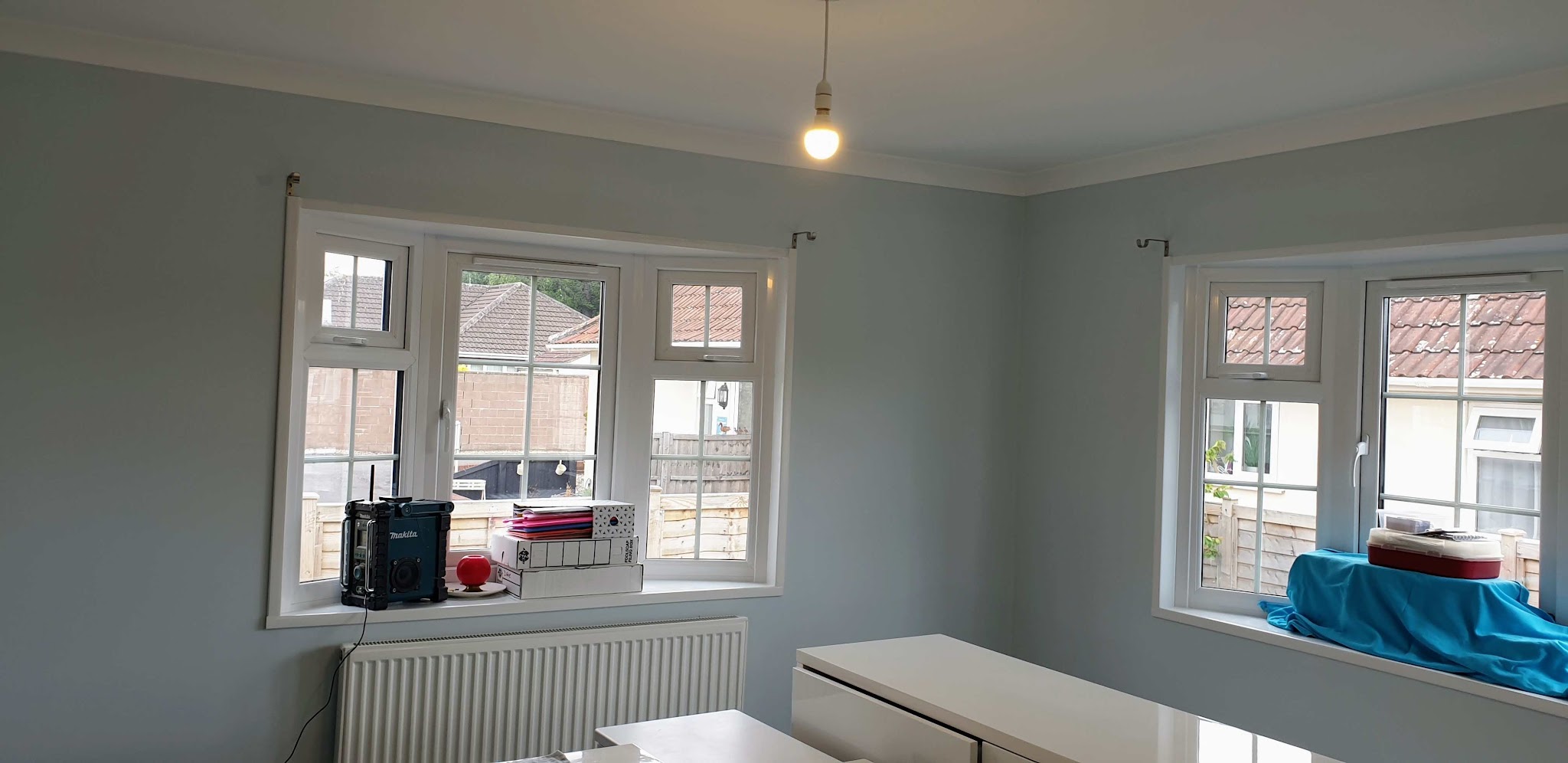Finished sage green room with white windows